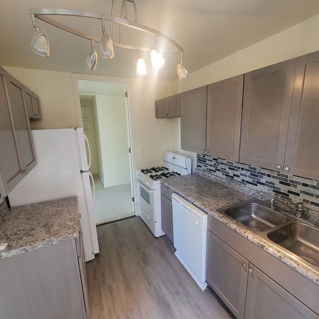 6700 S S Shore Dr Unit 2G, Chicago, IL 60649 - kitchen with white appliances, wood finished floors, tasteful backsplash, a sink, and light countertops