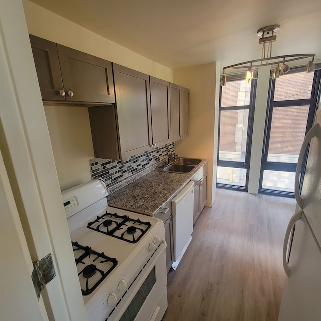 6700 S S Shore Dr Unit 2G, Chicago, IL 60649 - kitchen with white appliances, a sink, decorative backsplash, light wood-type flooring, and dark brown cabinets