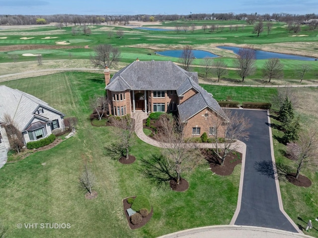 aerial view with golf course view and a water view