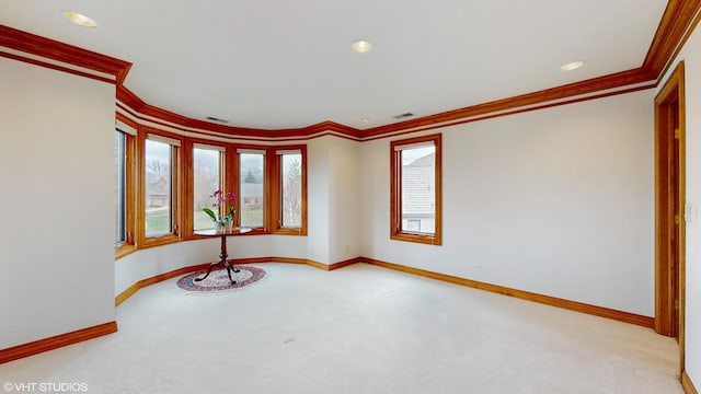 carpeted spare room featuring baseboards, visible vents, crown molding, and recessed lighting