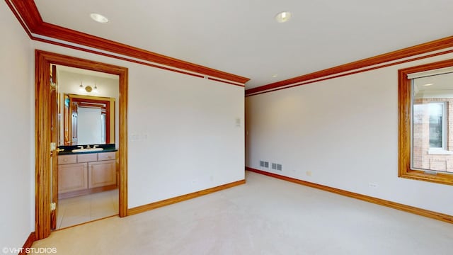 empty room featuring recessed lighting, light colored carpet, baseboards, visible vents, and crown molding