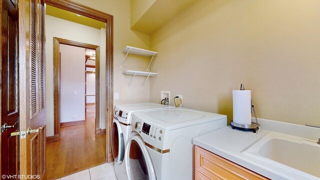 1611 Burr Oak Dr, Libertyville, IL 60048 - laundry area with independent washer and dryer, cabinet space, and light wood-style floors