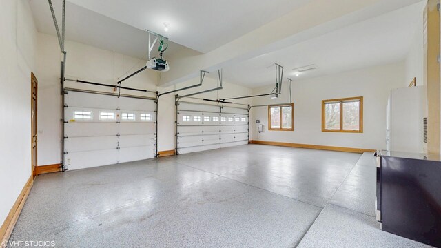 1611 Burr Oak Dr, Libertyville, IL 60048 - garage with a garage door opener, refrigerator, and baseboards