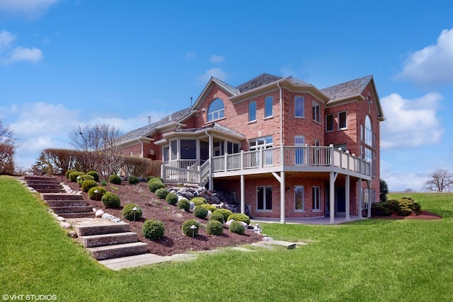 back of house with stairway, a patio area, a yard, a wooden deck, and brick siding