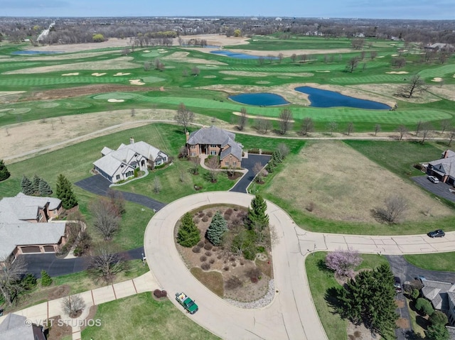 drone / aerial view featuring a residential view, a water view, and view of golf course