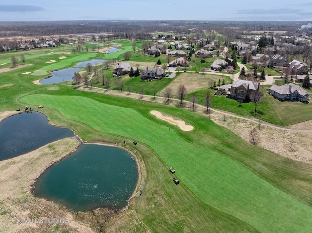 aerial view featuring golf course view, a residential view, and a water view
