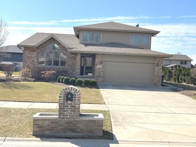 8837 Clifton Ln, Tinley Park, IL 60487 - view of front of home with driveway, brick siding, a front lawn, and roof with shingles