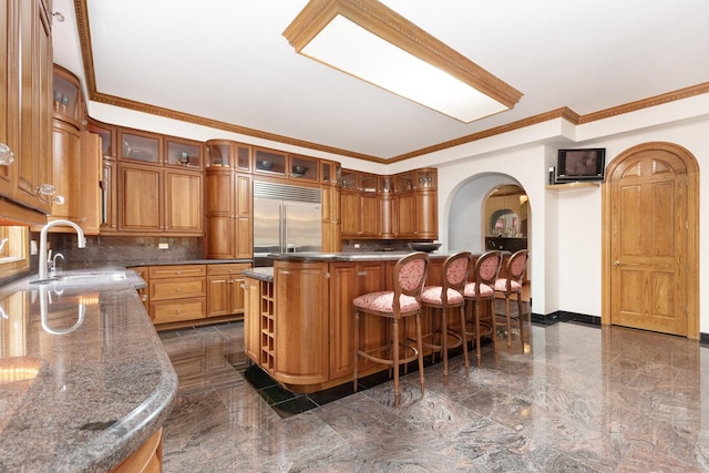 1020 Evergreen Dr, Lake Forest, IL 60045 - kitchen featuring arched walkways, built in fridge, a sink, tasteful backsplash, and crown molding
