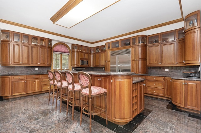 1020 Evergreen Dr, Lake Forest, IL 60045 - kitchen featuring built in appliances, brown cabinets, tasteful backsplash, and ornamental molding