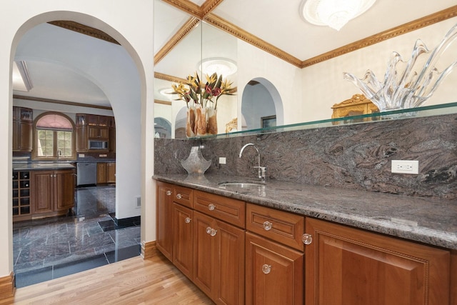 1020 Evergreen Dr, Lake Forest, IL 60045 - indoor wet bar featuring appliances with stainless steel finishes, backsplash, crown molding, arched walkways, and light wood-style floors