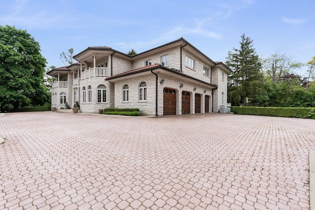 1020 Evergreen Dr, Lake Forest, IL 60045 - view of front facade featuring a balcony, stone siding, and driveway