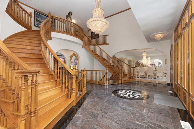 1020 Evergreen Dr, Lake Forest, IL 60045 - entrance foyer featuring a chandelier, arched walkways, stairs, a towering ceiling, and marble tiled floors