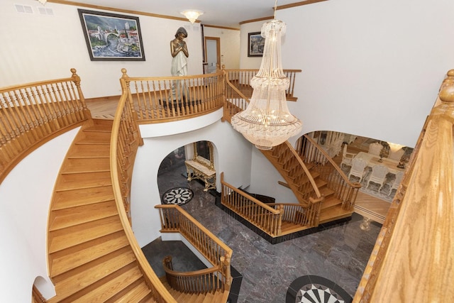 1020 Evergreen Dr, Lake Forest, IL 60045 - stairway with a chandelier and crown molding