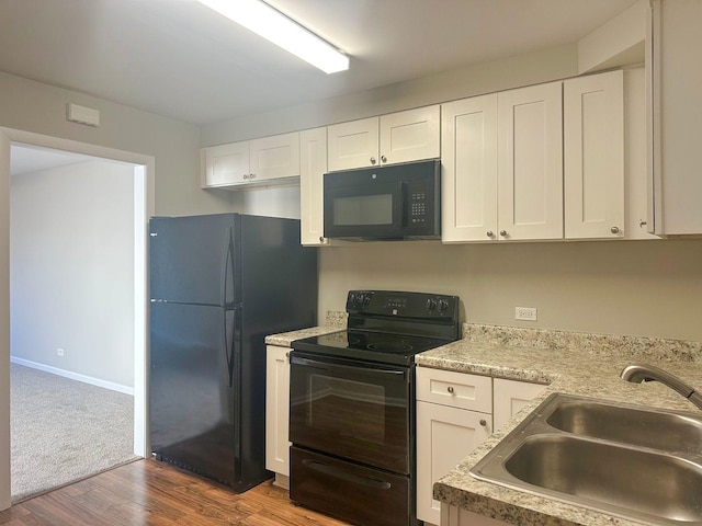 278 Rouse Ave, Mundelein, IL 60060 - kitchen featuring a sink, dark wood-style floors, white cabinets, and black appliances
