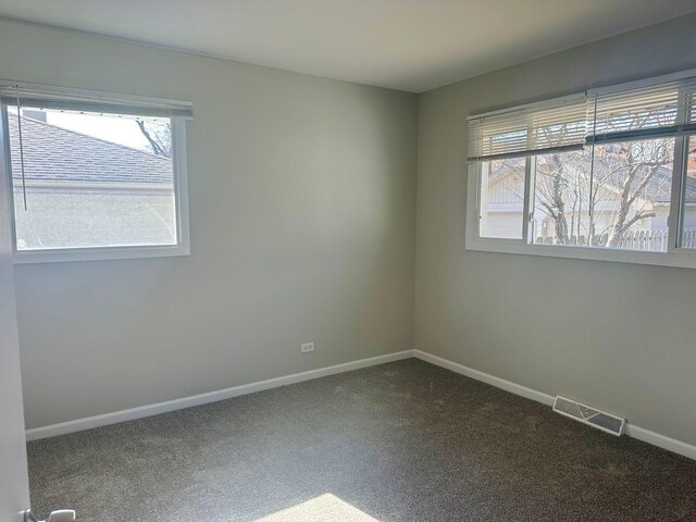 278 Rouse Ave, Mundelein, IL 60060 - empty room featuring baseboards, visible vents, and dark colored carpet