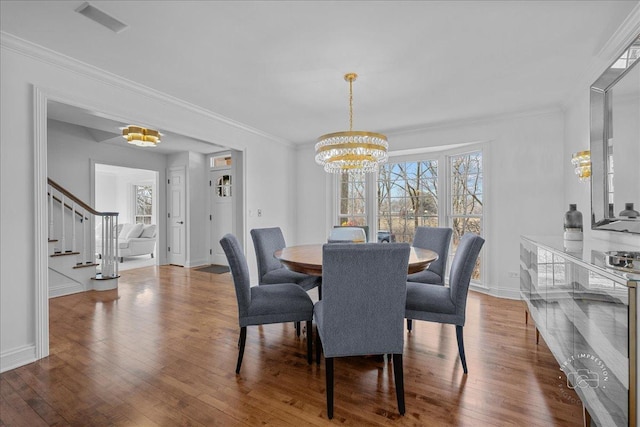 73 Brandon Ave, Glen Ellyn, IL 60137 - dining room featuring an inviting chandelier, ornamental molding, hardwood / wood-style flooring, and stairs