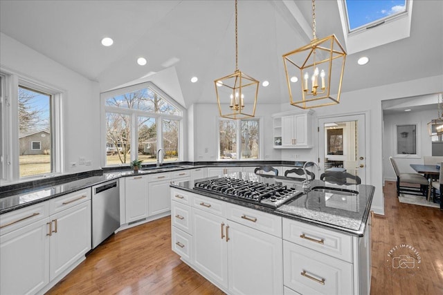 73 Brandon Ave, Glen Ellyn, IL 60137 - kitchen featuring vaulted ceiling, light wood-type flooring, an inviting chandelier, stainless steel appliances, and an island with sink