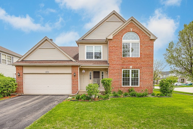 2031 Crosswind Dr, Plainfield, IL 60586 - view of front of home with a garage, a front lawn, roof with shingles, brick siding, and driveway