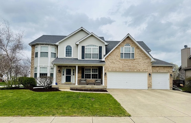 view of front facade with a front lawn, concrete driveway, covered porch, brick siding, and an attached garage