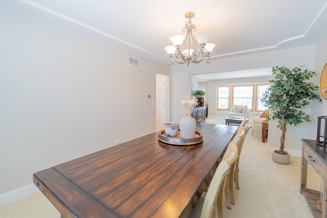 dining area with baseboards, visible vents, light colored carpet, and an inviting chandelier