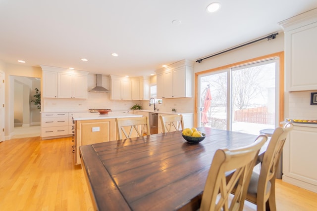 dining room with light wood-style floors and recessed lighting