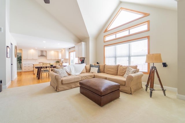 living area featuring recessed lighting, baseboards, high vaulted ceiling, and light carpet