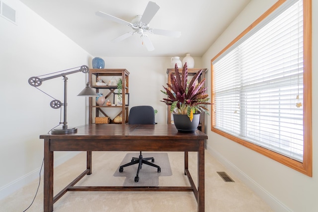 carpeted office space with baseboards, visible vents, and plenty of natural light