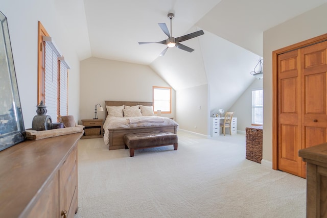 bedroom featuring vaulted ceiling, light colored carpet, and a ceiling fan