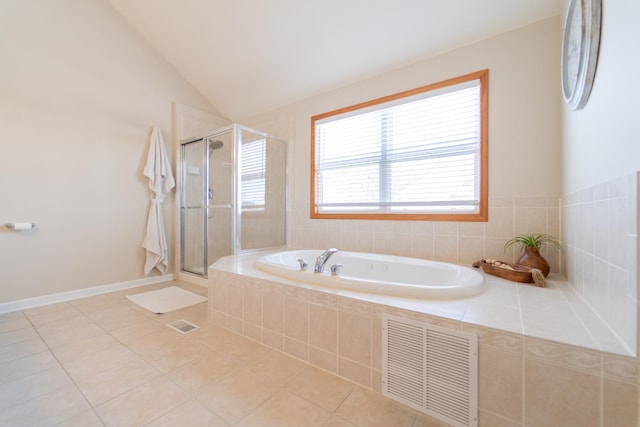 bathroom with tile patterned floors, vaulted ceiling, visible vents, a garden tub, and a stall shower