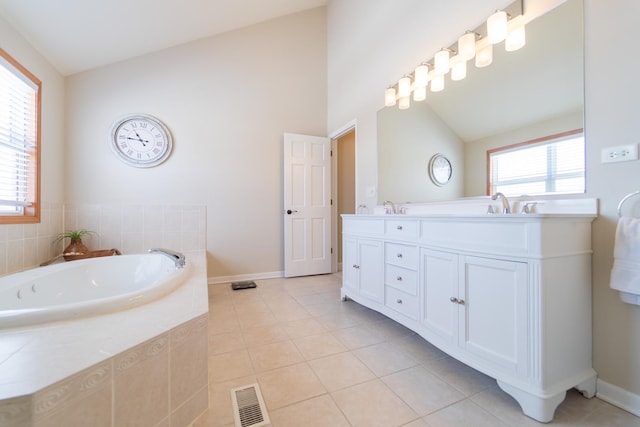 bathroom with vaulted ceiling, a bath, double vanity, tile patterned flooring, and visible vents