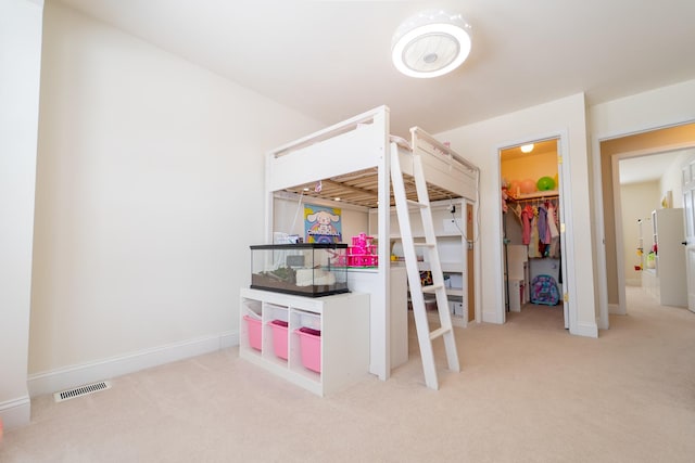 bedroom with baseboards, visible vents, and carpet
