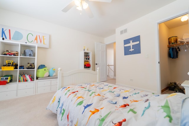 bedroom with a ceiling fan, visible vents, carpet floors, and a closet
