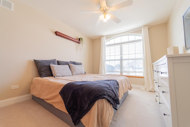 bedroom featuring light colored carpet, ceiling fan, baseboards, and visible vents