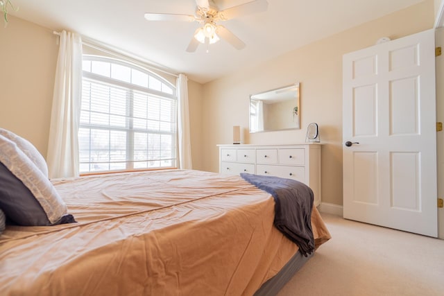 bedroom featuring a ceiling fan, baseboards, and light carpet