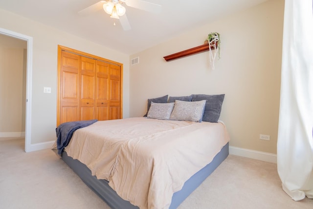 bedroom featuring a ceiling fan, baseboards, a closet, and carpet