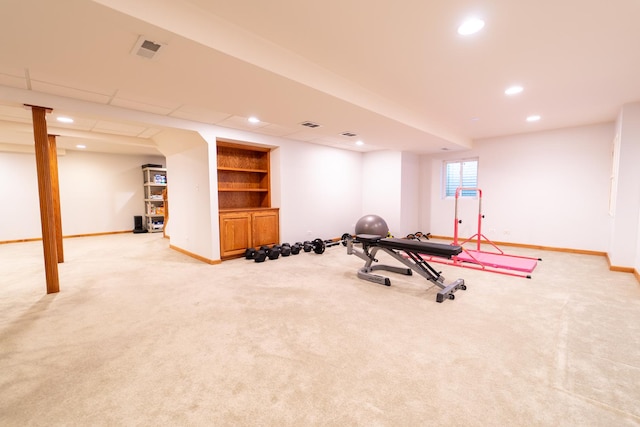 exercise area featuring recessed lighting, visible vents, light carpet, baseboards, and built in features