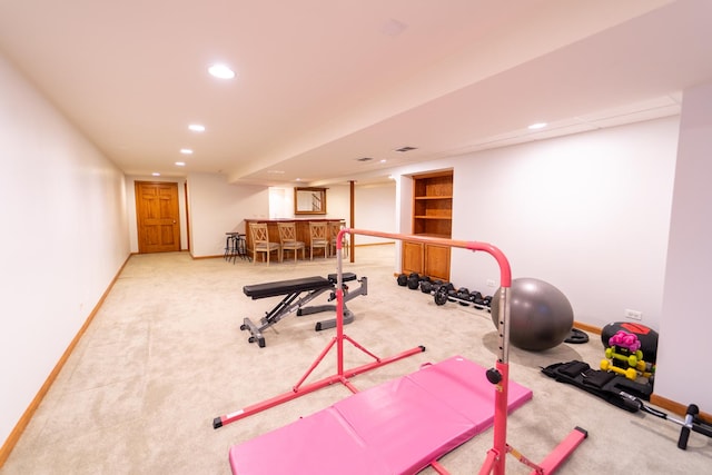 workout area featuring recessed lighting, carpet flooring, baseboards, and bar