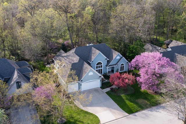 drone / aerial view featuring a forest view