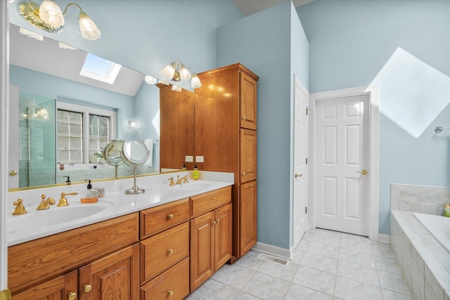 full bathroom featuring a sink, vaulted ceiling with skylight, double vanity, tile patterned floors, and a garden tub