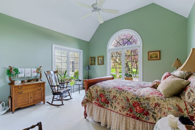 bedroom with a ceiling fan, high vaulted ceiling, light carpet, and multiple windows