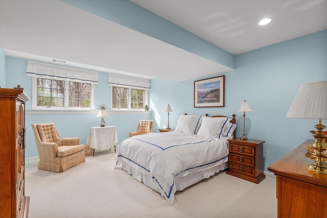 carpeted bedroom featuring recessed lighting, visible vents, and multiple windows