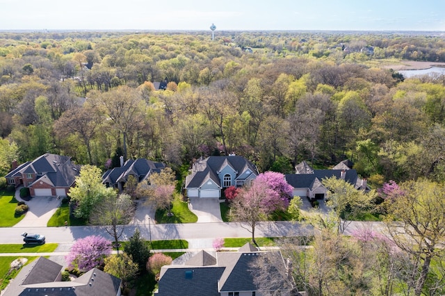 drone / aerial view with a forest view and a residential view