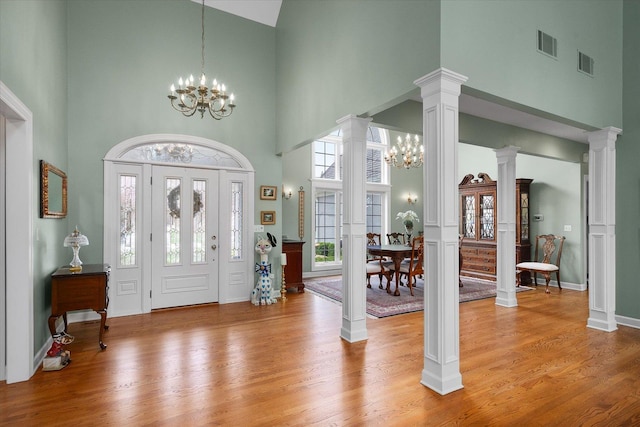 entrance foyer with high vaulted ceiling, a chandelier, and visible vents