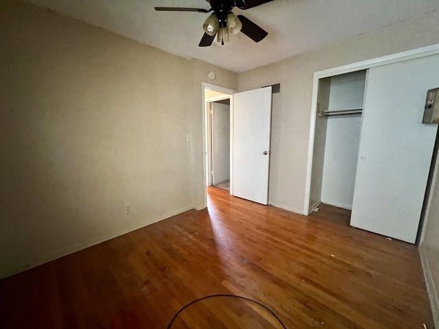 1101 N Coler Ave, Urbana, IL 61801 - unfurnished bedroom with wood finished floors, a closet, and a ceiling fan