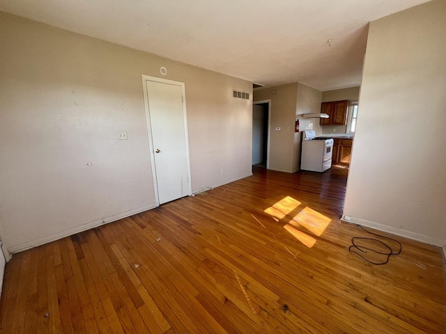 1101 N Coler Ave, Urbana, IL 61801 - unfurnished living room with hardwood / wood-style flooring and baseboards