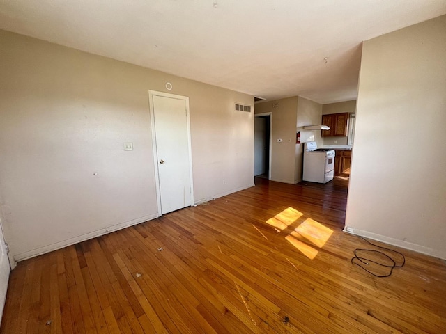 1101 N Coler Ave, Urbana, IL 61801 - unfurnished living room with hardwood / wood-style floors and baseboards