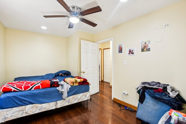 bedroom featuring baseboards, ceiling fan, and wood finished floors