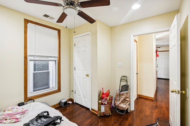 bedroom featuring a ceiling fan, dark wood-style floors, baseboards, and visible vents
