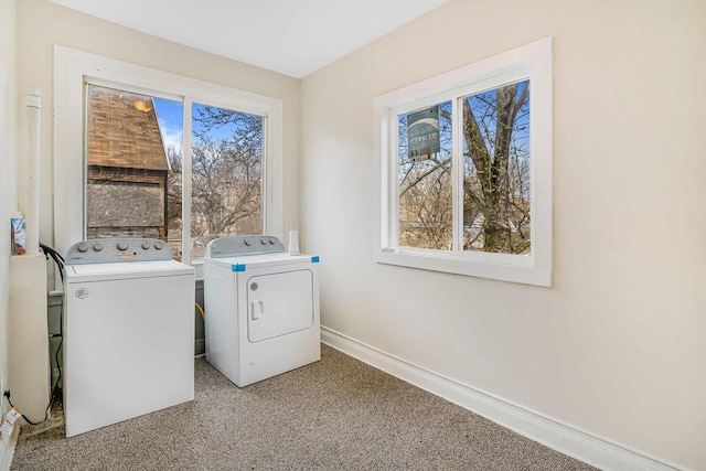 laundry area featuring baseboards, washer and dryer, light carpet, and laundry area