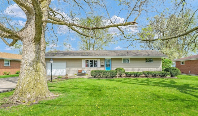 view of front of property with a front yard and a garage